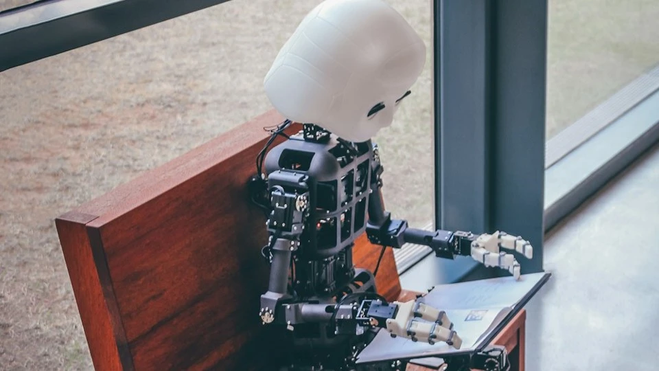 Robot looking at a tablet